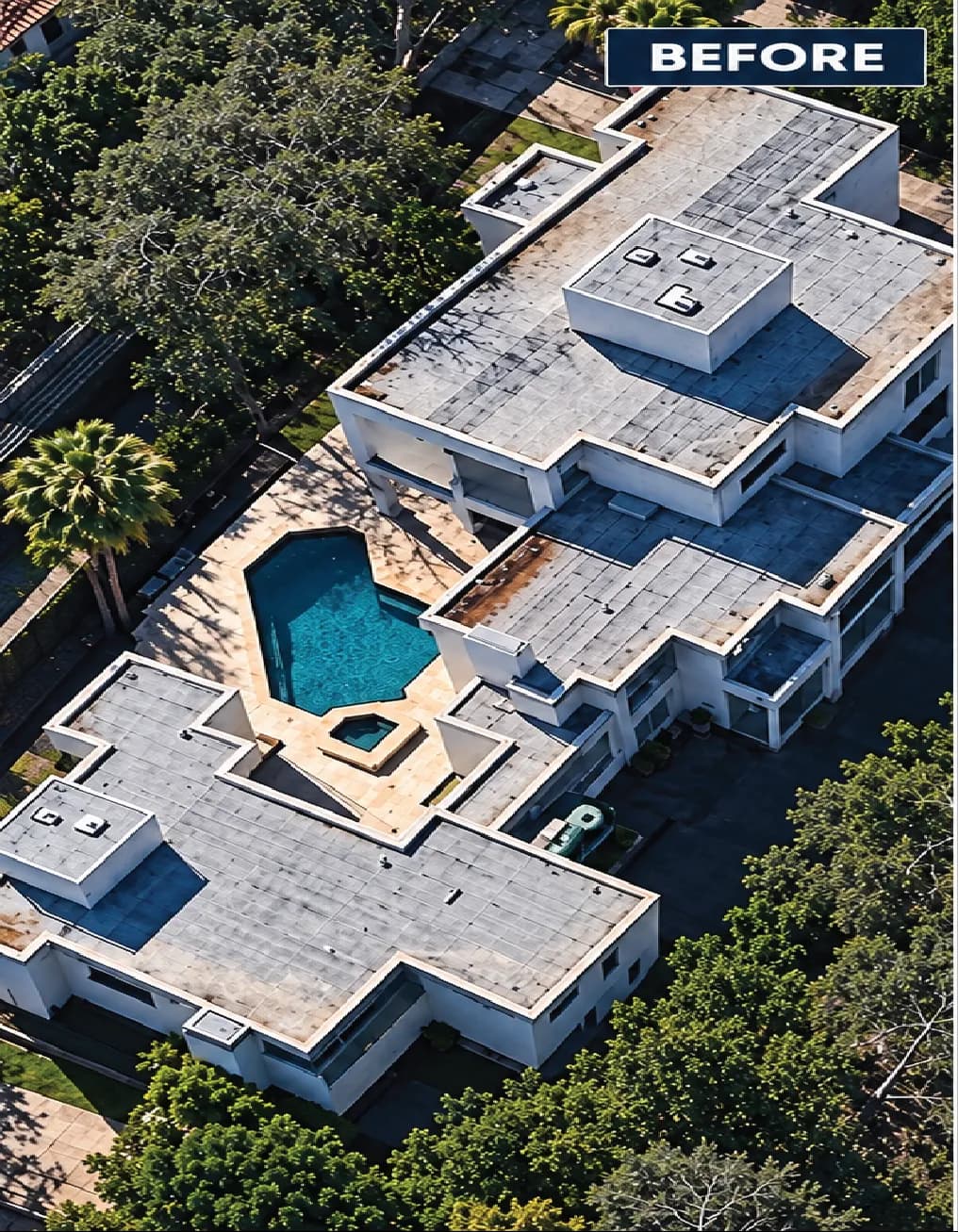 Aerial view of modern home with pool, showcasing roof before renovations, surrounded by greenery.